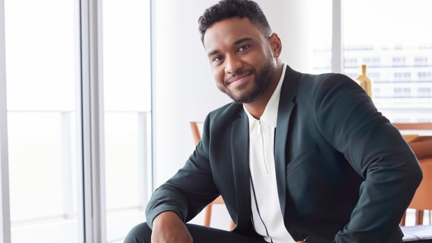 Tua Tagovailoa models a navy Perry Ellis suit.